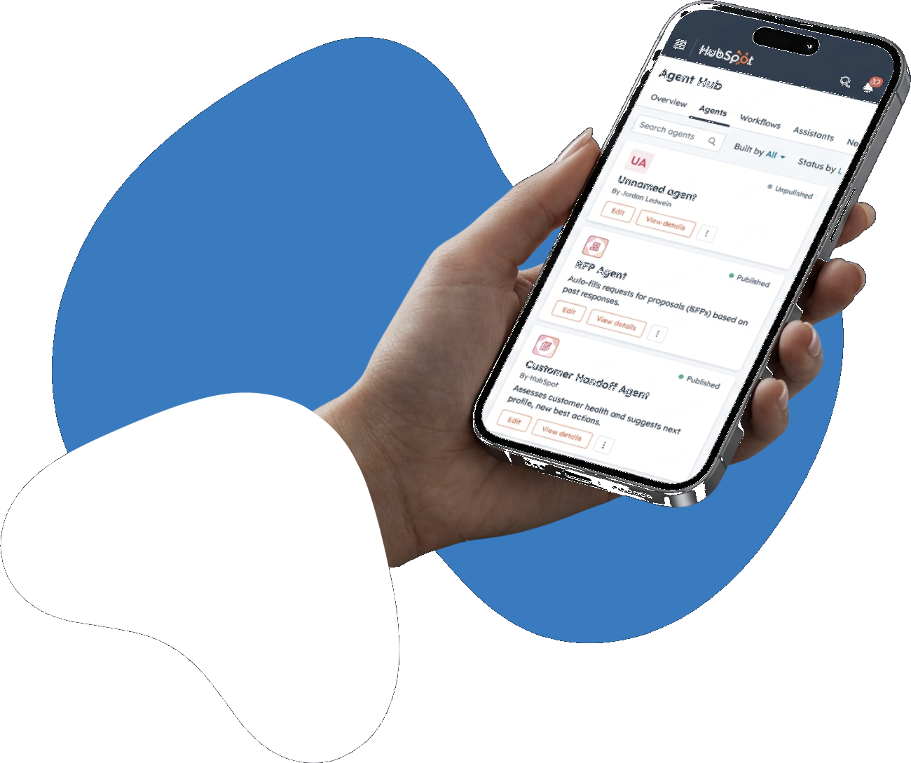Hand holding a phone showing the HubSpot Agent Hub screen, in front of blue and white graphic shapes